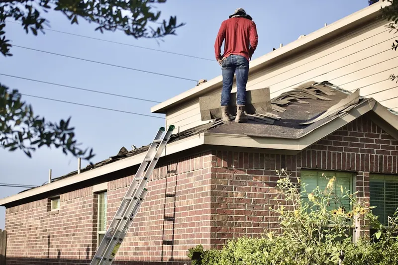 Professional roofer working on a residential roof in Bayberry